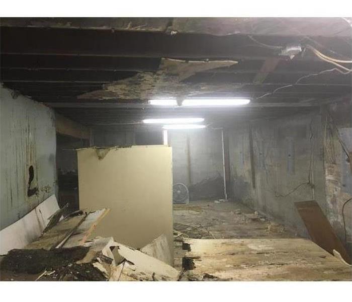 Picture of a basement with ceiling falling down from water damage