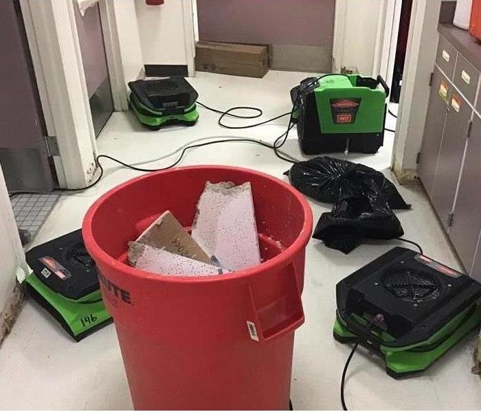 air movers in a water damage, wet floor, wet walls