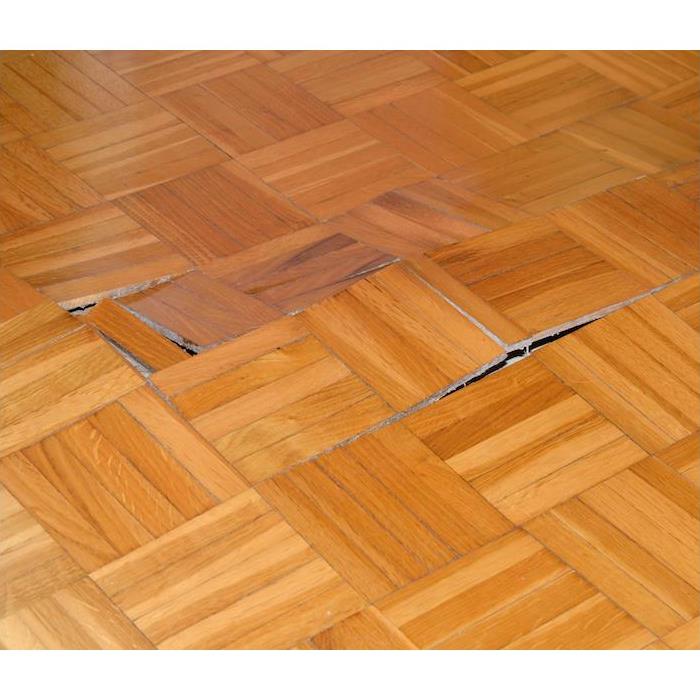 parquet light brown wood flooring popped up from water damage near Gillette