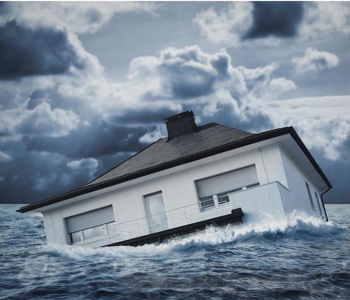 ”house.jpg” alt = “a house floating in a large body of water" >