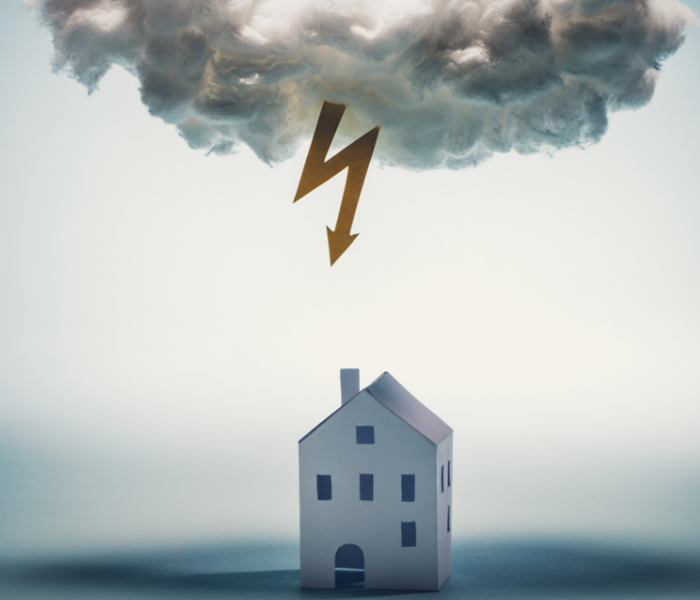 a lighting bolt coming at a single standing house